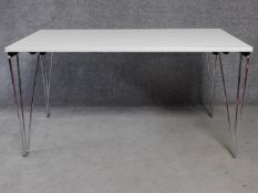 A folding trestle table on chrome supports. H.74 L.140 W.71cm