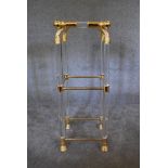 An Empire style gilt framed lamp table with clear perspex and glass fittings, shelves and tops and