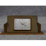 An Art Deco brass desk clock by Europa. Luminous numbers. Geometric form with linear detailing. H.