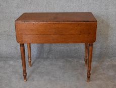 A Victorian mahogany drop flap Pembroke table on ring turned tapering supports. H.77 x 86cm (ext