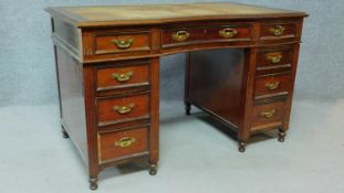 A late 19th century mahogany pedestal desk with leather inset top above an arrangement of nine