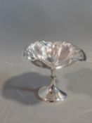 An Edwardian silver pedestal dish with an Art Nouveau style floral and foliate design. Hallmarked: