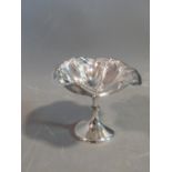 An Edwardian silver pedestal dish with an Art Nouveau style floral and foliate design. Hallmarked: