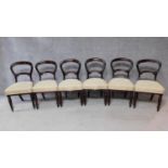 A set of six Victorian mahogany balloon back dining chairs on turned tapering supports. H.89cm