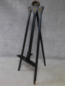A late Victorian ebonised easel with gilt detailing. H.146cm
