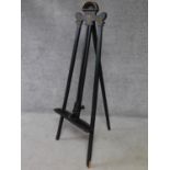 A late Victorian ebonised easel with gilt detailing. H.146cm