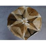 A circular goat skin rug with star pattern. 148x148cm