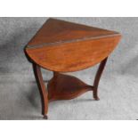 An Edwardian mahogany and satinwood inlaid drop flap occasional table on cabriole supports united by