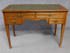 A 19th century oak writing table with leather inset top above two long frieze drawers and two