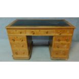 A 19th century oak leather top desk with central long frieze drawer and eight short drawers. H.75