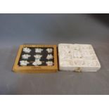 A collection of boxed Coalport and Royal Staffordshire white porcelain floral menu holders. H5cm.