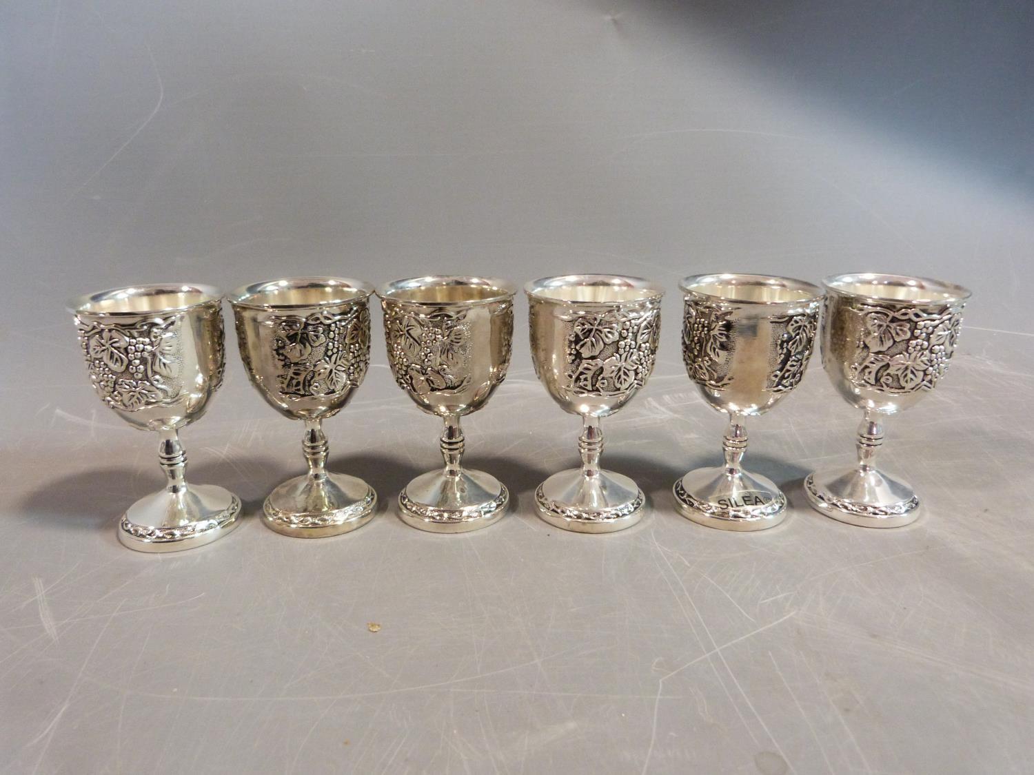 A set of six white metal silea vine design kiddush cups. H.8cm.