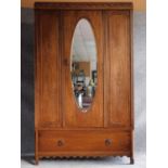A mid 20th century oak wardrobe with hanging space above base drawer. H.192 W.118 D.44cm
