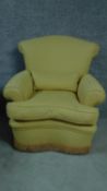 A contemporary armchair upholstered in lemon fabric. H.80cm