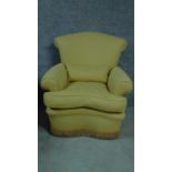 A contemporary armchair upholstered in lemon fabric. H.80cm
