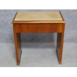 An Art Deco figured walnut piano stool with hinged lift up top enclosing sheet music compartment.