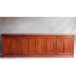 A 19th century mahogany low library bookcase with two pairs of panel doors enclosing shelves on