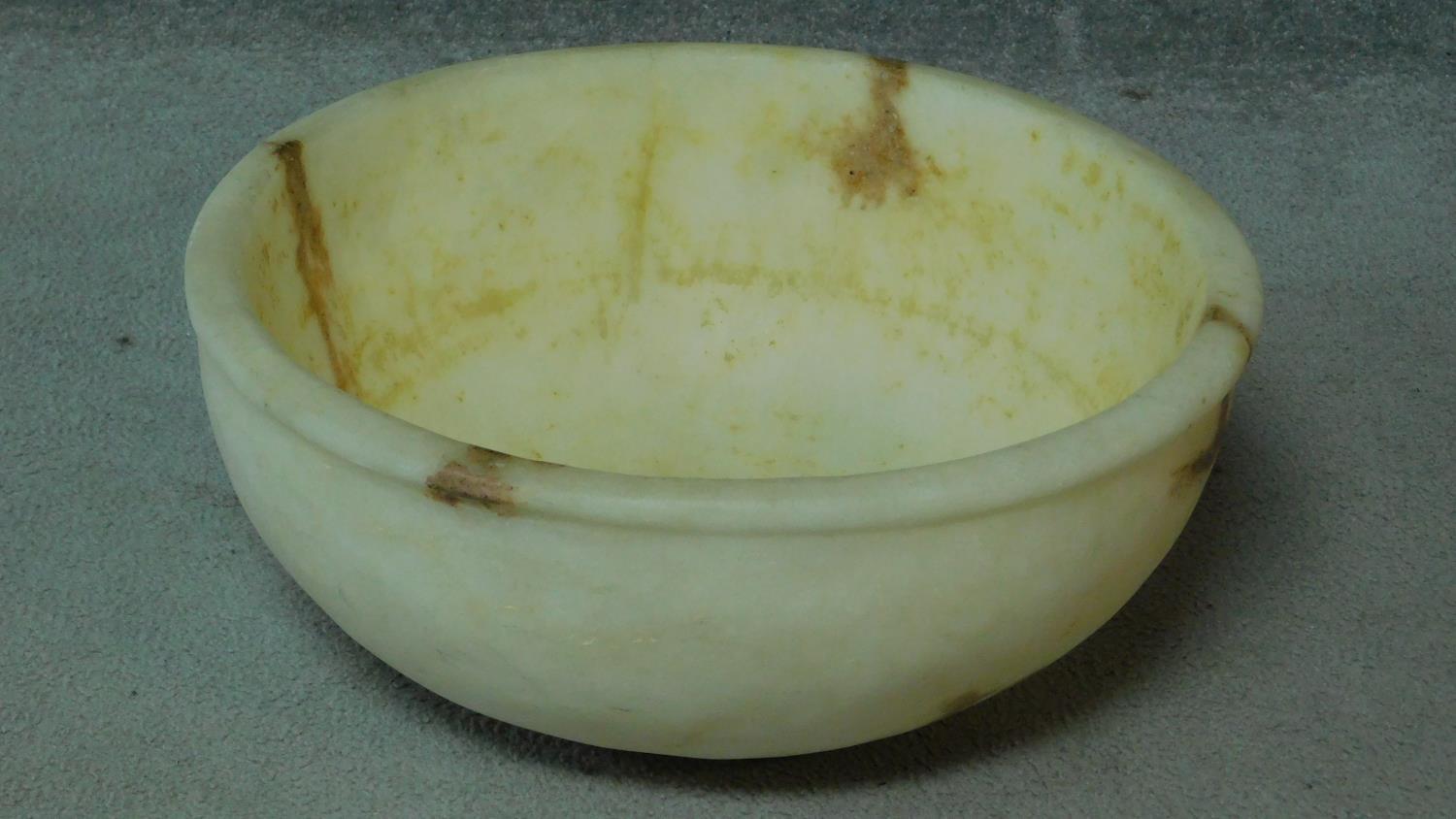 A carved alabaster lipped bowl. H.16 W.45 D.45cm