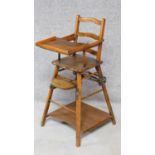 A beech framed metamorphic child's high chair that changes to a low wheeled play table, the table is