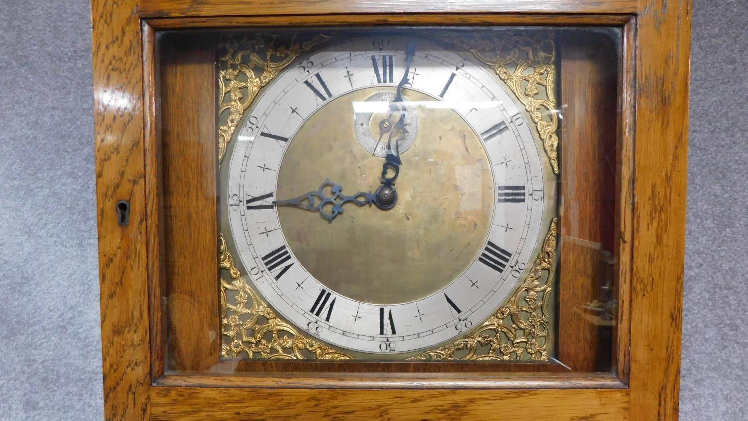 An oak cased grandfather clock, with gilded repousse detailing to the face. Black roman numerals - Image 3 of 5