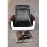 A retro style barber's chair with rise and fall and fully reclining action on chrome base. H.97 x