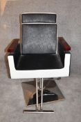 A retro style barber's chair with rise and fall and fully reclining action on chrome base. H.97 x