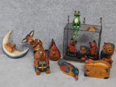 A collection of painted wooden figures of animals and a moon. With a wire basket. H.30cm