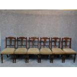 A set of six late Victorian carved walnut dining chairs raised on turned tapering supports. H.91cm