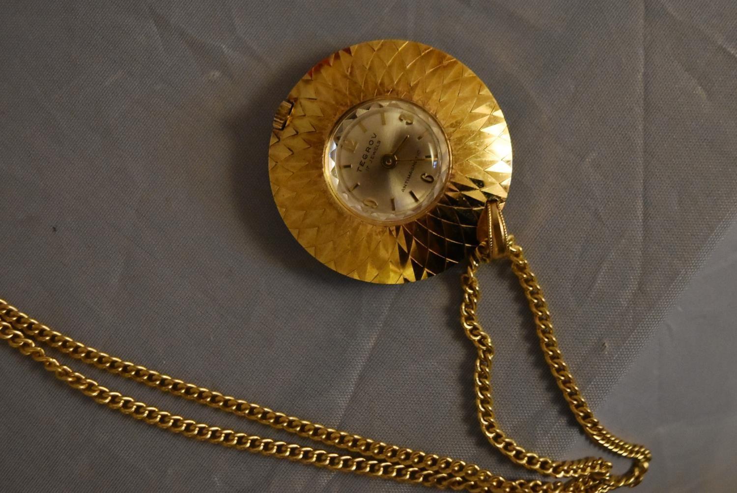 A vintage Tegrov gold tone pendant antimagnetic watch and chain. Impressed floral design to the back - Image 3 of 5