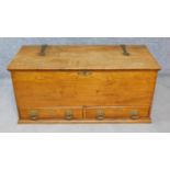 A late 19th century elm blanket box fitted with two base drawers and Arts and Crafts style brass