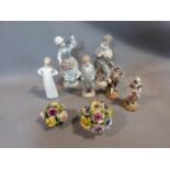 A collection of porcelain Lladro figures and ornaments. Including two porcelain flower baskets one