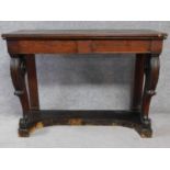 An early 19th century oak console table with two frieze drawers on carved cabriole front supports.