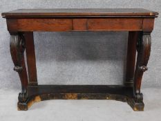 An early 19th century oak console table with two frieze drawers on carved cabriole front supports.