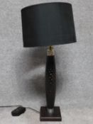 A carved wood and metal collared table lamp with square base. Fitted with dimmer switch. H.83cm