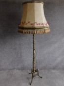 A vintage tripod base brass standard lamp with sectioned detailing. H.176cm