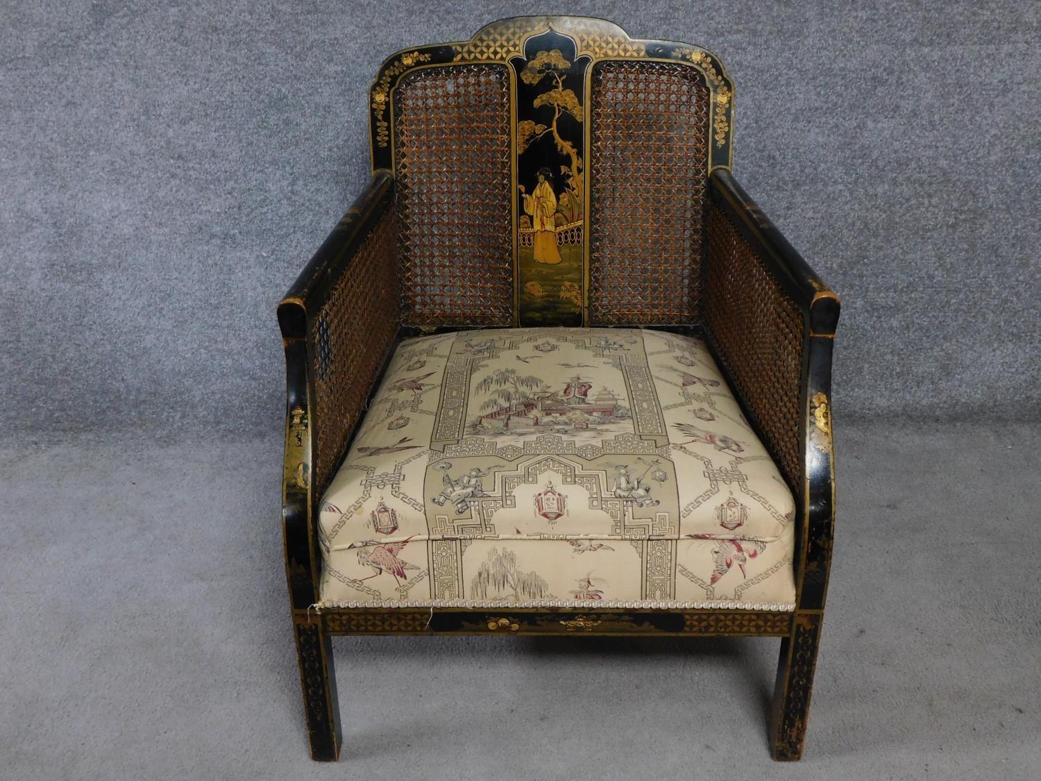 A Japanned and lacquered bergere style armchair on square supports. H.81 W.76 D.66cm