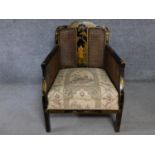 A Japanned and lacquered bergere style armchair on square supports. H.81 W.76 D.66cm