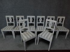 A set of eight Continental style painted dining chairs with floral carved backsplat on square