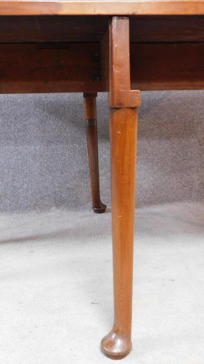 A Georgian Cuban mahogany drop flap gateleg dining table on six pad foot supports. H.70xW.119xD. - Image 4 of 4