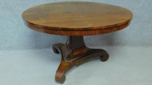 A Regency rosewood circular tilt top loo table on pedestal tripod base. H.73 L.123 W.123cm