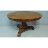 A Regency rosewood circular tilt top loo table on pedestal tripod base. H.73 L.123 W.123cm