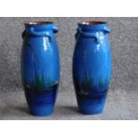 A large pair of twisted handled Watcombe Torquay pottery vases, the blue ground painted with