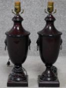 A pair of regency style metal urn lamp bases with lions head handles. Hardstone effect to the metal.