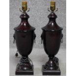 A pair of regency style metal urn lamp bases with lions head handles. Hardstone effect to the metal.