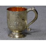 A Corbell and Co silver plated and gilded tankard with repousse floral design and scrolling