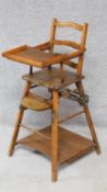 A beech framed metamorphic child's high chair that changes to a low wheeled play table, the table is