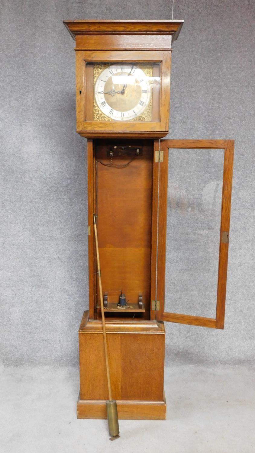 An oak cased grandfather clock, with gilded repousse detailing to the face. Black roman numerals - Image 2 of 5