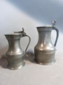 Two lidded pewter tankards, circa 1800. One with acorn detailing to handle and one with a scallop