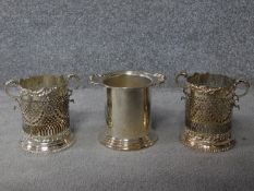 A pair of antique pierced silver plate wine holders along with an art deco silver plate wine