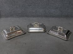 Three Georgian lidded Sheffield plate warming dishes with detachable handles. Engraved with armorial